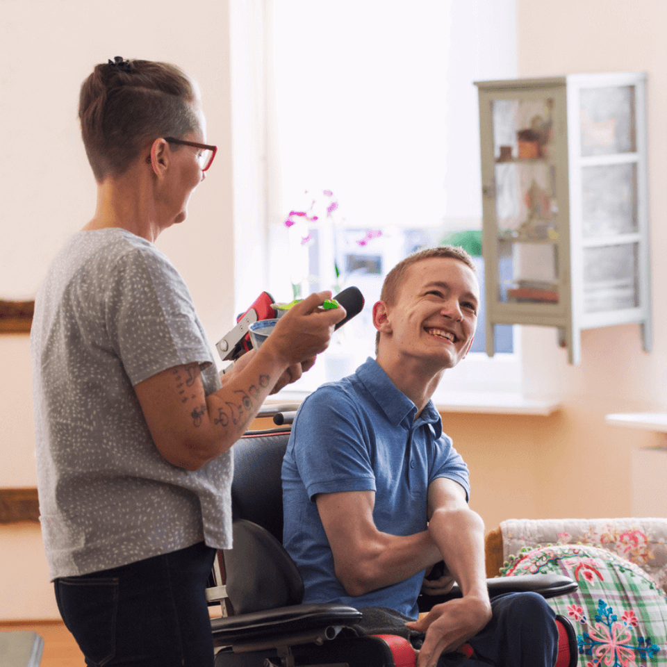 participant and carer smiling